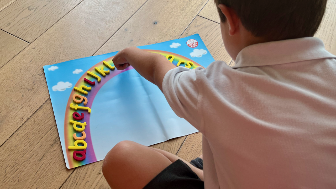 boy pointing at letters